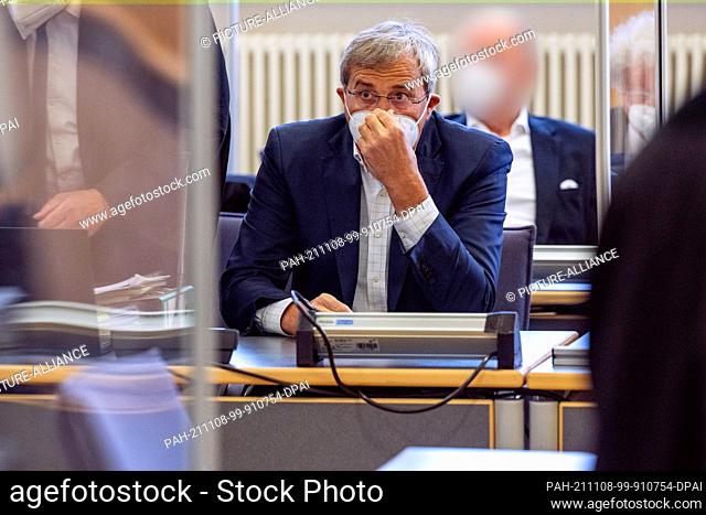 08 November 2021, Bavaria, Regensburg: Franz Rieger (M), CSU member of the Bavarian parliament, sits in front of a co-defendant (back) in the courtroom at the...