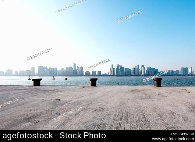 empty concrete floor and cityscape of hangzhou qianjiang new district in blue sky