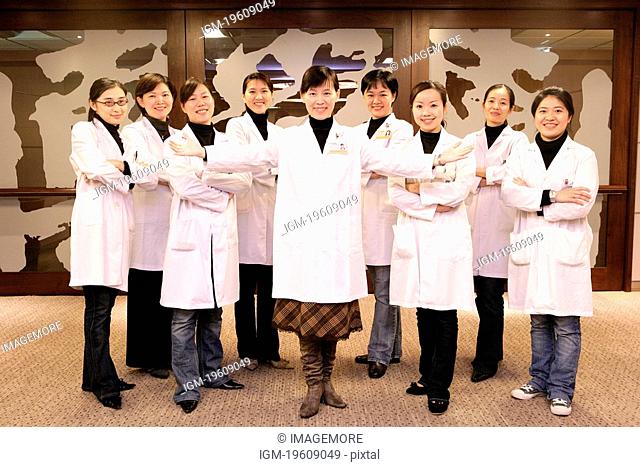 Nine medical persons standing together