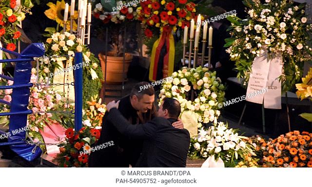 Former boxing pros and world champions Vitali Klitschko (L) and Artur Grigorian (R) embrace during the funeral service of late boxing coach Fritz Sdunek in...