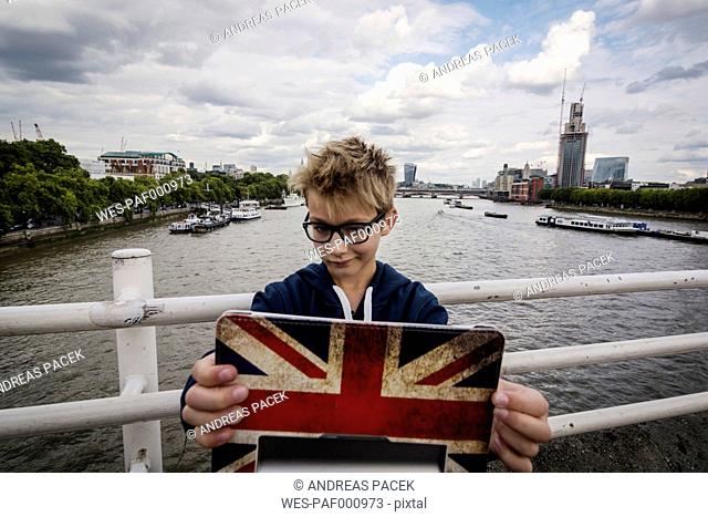UK, London, portrait of boy taking a selfie with his digital tablet