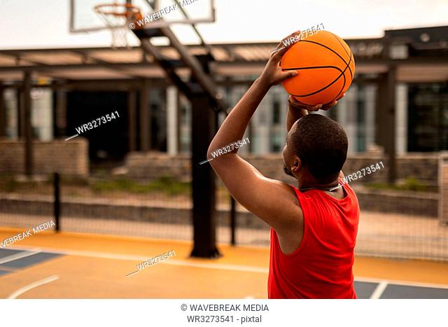 Basketball player playing basketball at basketball court