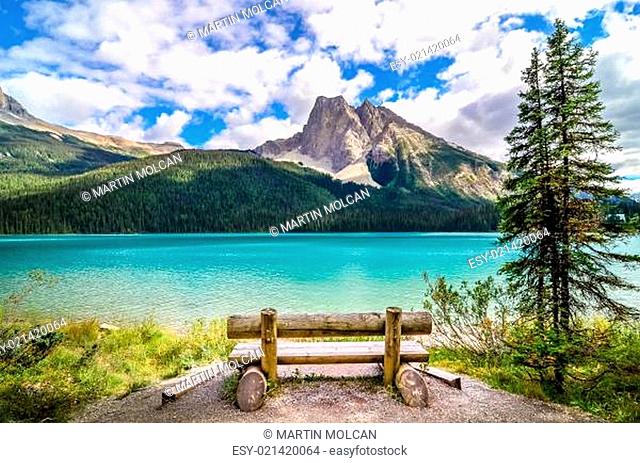 Scenic view of mountain lake and wooden bench
