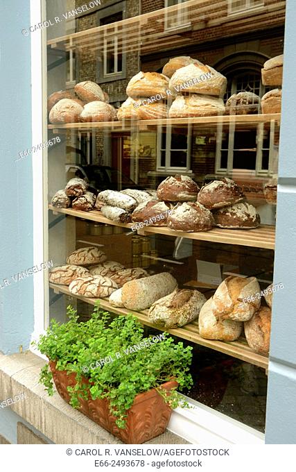 Window of artinasal bakery shop in Maastricht, Limburg, the Netherlands. Here, in addition to bread you can buy locally made cheeses, hand made lemon curd