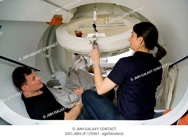 Cosmonaut Roman Romanenko and NASA astronaut Nicole Stott, both Expedition 2021 flight engineers, participate in a training session in the Space Vehicle Mock-up...