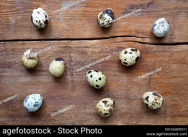 many quail eggs lay on vintage wooden surface