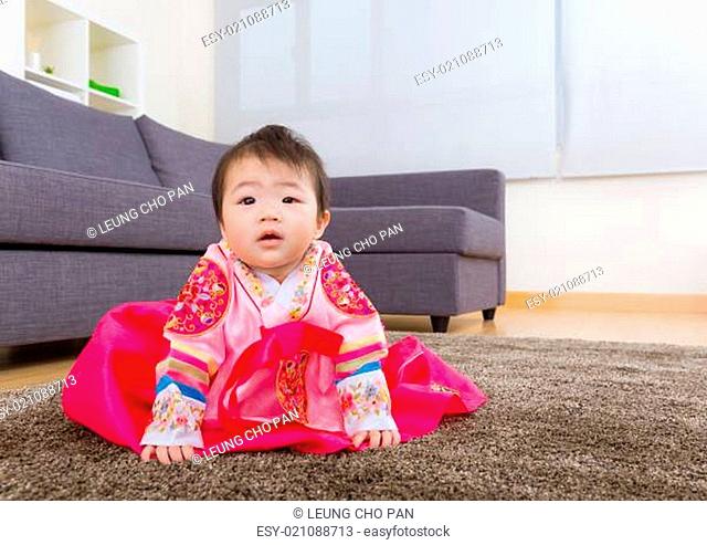 Traditional Korean dressing baby sitting on carpet