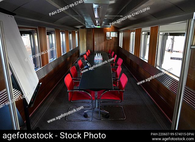 03 June 2022, Brandenburg, Potsdam: Office furniture and a flipchart stand in the Kaiserbahnhof in the restored salon car of the Empress Auguste Viktoria from...