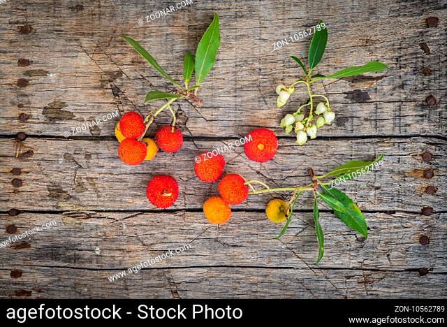 Delicious fresh arbutus fruits on a wooden table
