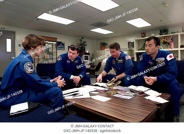 The STS-114 crewmembers are photographed during a briefing prior to a flight in T-38 trainer jets at Ellington Field near Johnson Space Center (JSC)