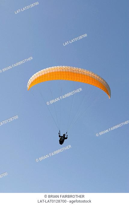 Paragliding is becoming a popular sport on the island of Malta, whereby participants are strapped to a parachute and propelled by a small engine through the sky