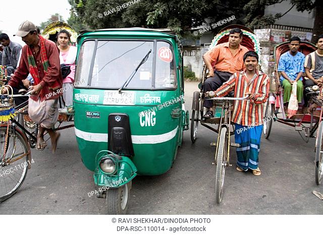 Street scene ; Auto-Rickshaw tempo and Cycle rickshaw rider with passenger traffic in Dhaka ; Bangladesh