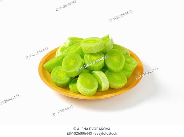 plate of leek slices on white background