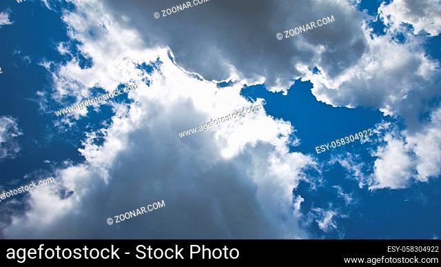 The dark blue sky with cumulus clouds