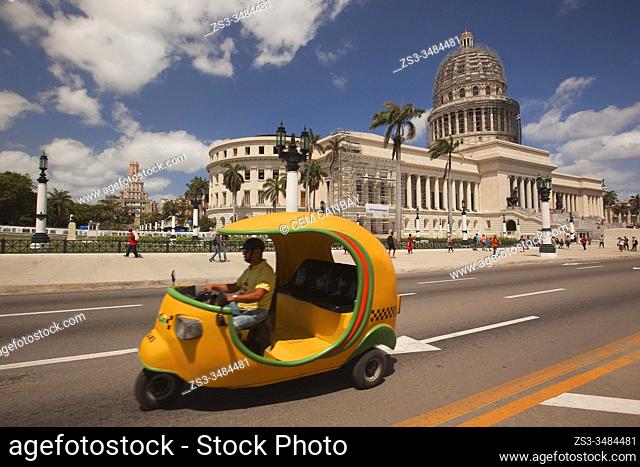 Street scene with a coco-taxi used as a taxi in front of the Capitolio building in Central Havana, La Habana, Cuba, West Indies, Central America