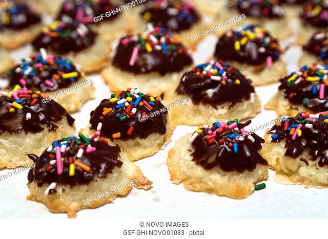 Macaroon Cookies Dipped in Chocolate With Colorful Sprinkles