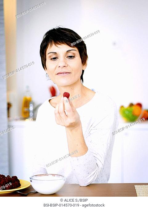 Woman eating raspberries