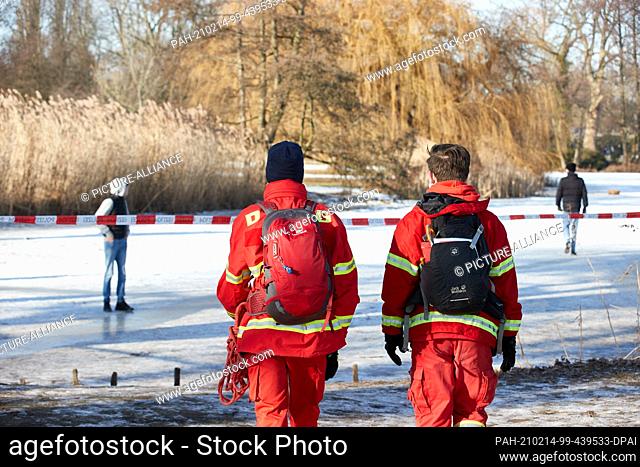 14 February 2021, Hamburg: Two schoolchildren and members of the German Life Saving Association (DLRG) Wandsbek take tours around the Alster and point out the...