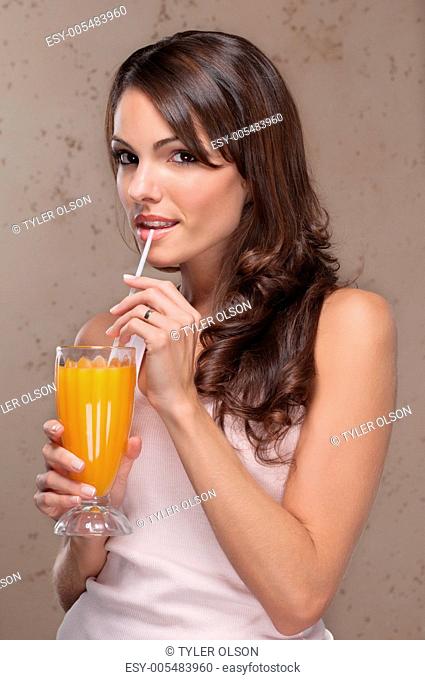 Portrait of woman drinking orange juice