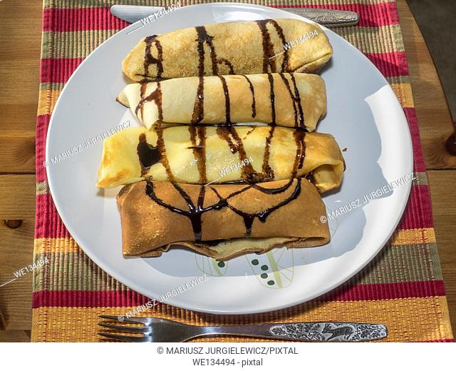 Homemade crepes filled with cream cheese and raisins