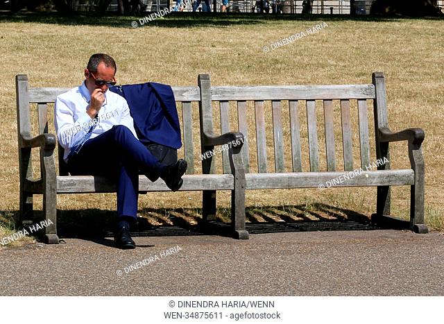Londoners enjoy on another hot and humid day in the Green Park. Dry and hot weather is likely to continues in Britain for the rest of the week