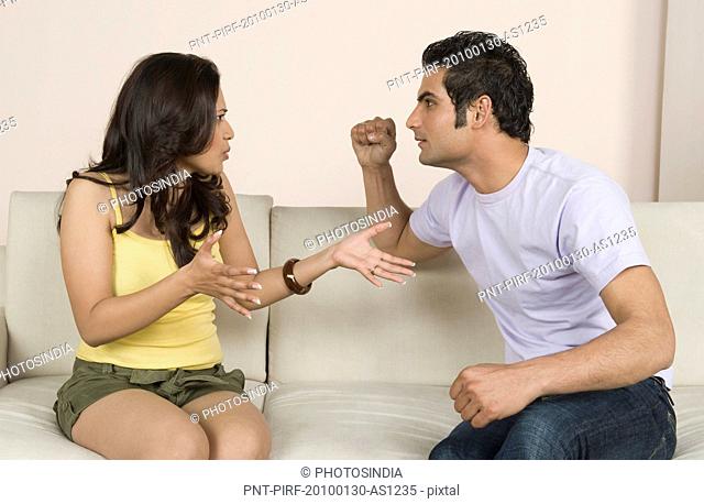 Couple arguing on a couch