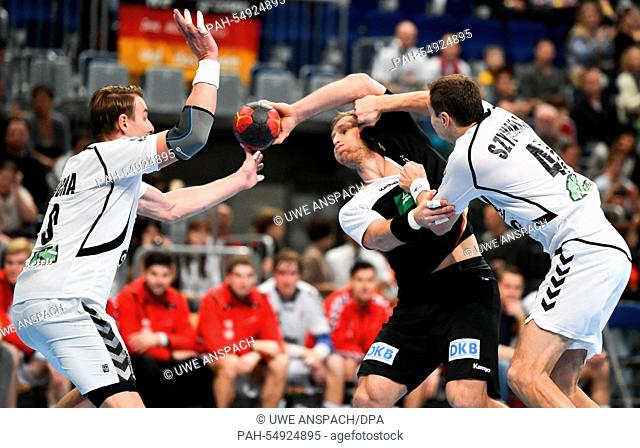 Jakub Szymanski and Filip Jicha (L) of Czech Republic vies for the ball with Steffen Weinhold (C) of Germany during the handball international match Germany vs...