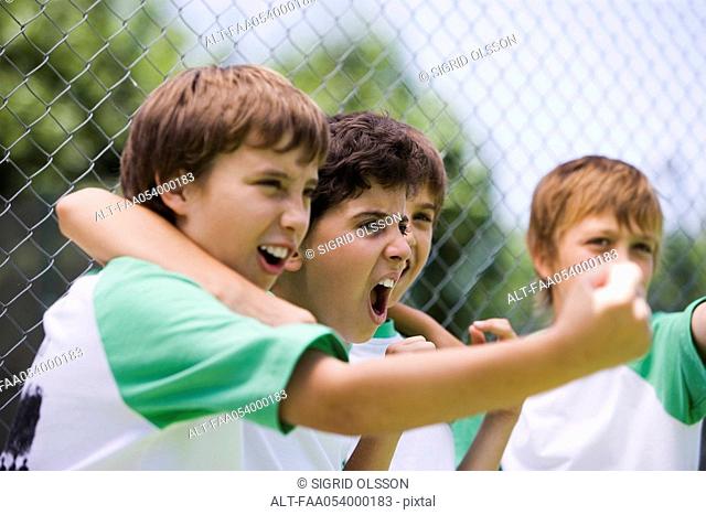 Young teammates cheering from sidelines