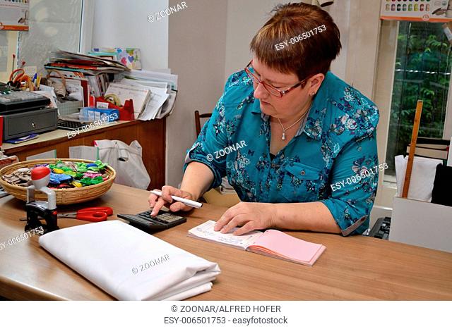 Business woman expects on calculator