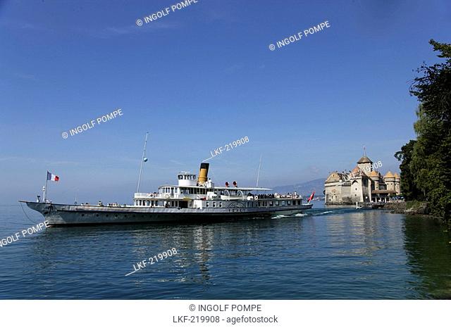 Excursion boat on Lake Geneva arriving Chillon Castle, Veytaux, Vaud, Switzerland