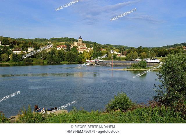 France, Val-d'Oise, a barge on the Seine river in front of Vetheuil and its Notre Dame church painted by Claude Monet