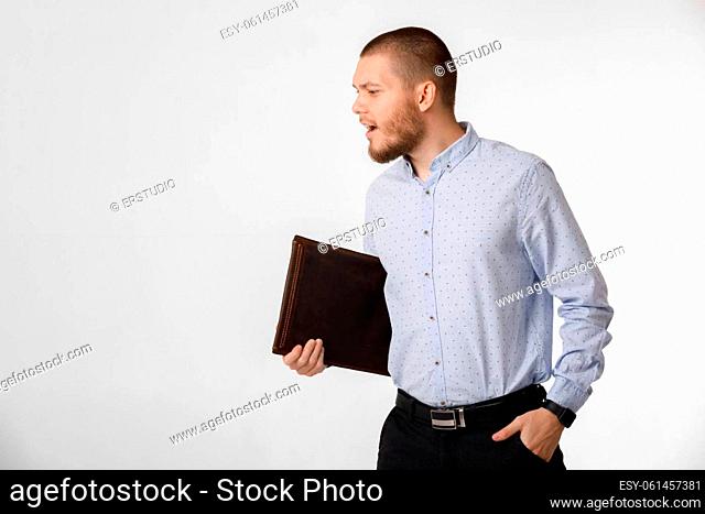 bearded businessman holding leather case on white background