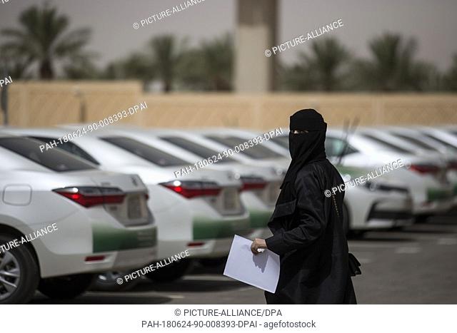 A Saudi woman arrives at the Saudi Driving School inside Princess Nora University to attend driving lessons on the first day after lifting the driving ban on...
