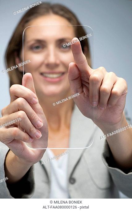 Businesswoman using transparent digital tablet
