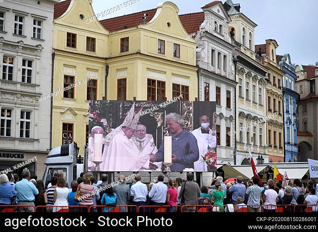 Prague Archbishop Cardinal Dominik Duka on the large screene, left, celebrates a divine service in the Church of our Lady before Tyn in Prague, Czech Republic