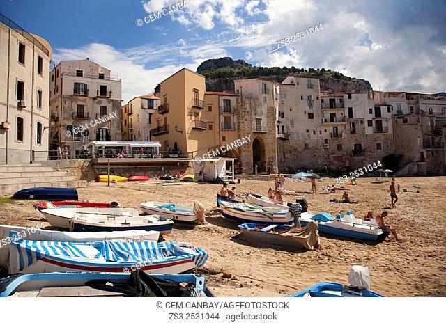 Scene from the the beach with the houses of the town at the background, Cefalu, Sicily, Italy, Europe