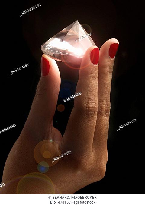 Sparkling gemstone, hand