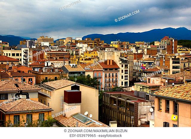 Romantic white city on hills - Spanish town Girona in foothills of Pyrenees - between peaks of Pyrenees mountains and Mediterranean sea