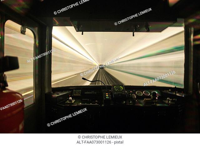 Train moving through tunnel, viewed through window