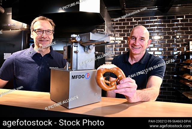 PRODUCTION - 02 February 2023, Baden-Württemberg, Stuttgart: Michael Feil (l) and Dieter Obertautsch (r), the inventors and developers of a butter pretzel...