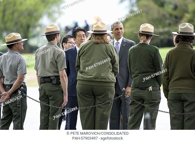 President Barack Obama and Prime Minister Shinzo Abe of Japan stop to talk to U.S. Park Rangers as they visit the Lincoln Memorial in Washington