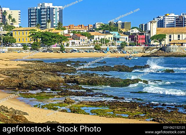Red River beach which is known as the bohemian neighborhood of the city of Salvador in Bahia with its rocks, boats and houses on a sunny summer day