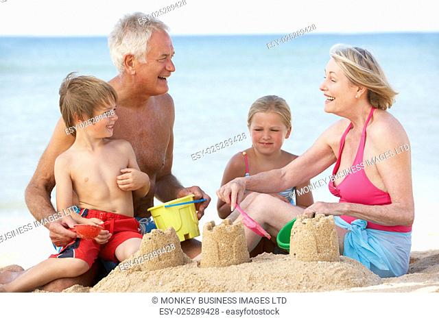 Grandparents And Grandchildren Enjoying Beach Holiday