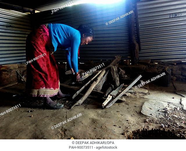 The 51-year-old woman Chinimaya Shrestha standing in a corrugated iron hut, her refuge since the 2015 earthquake which destroyed her house and buried her...
