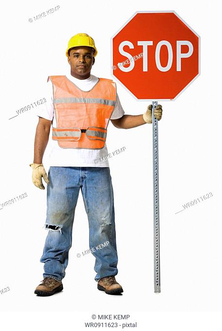 Road worker with stop sign and hardhat