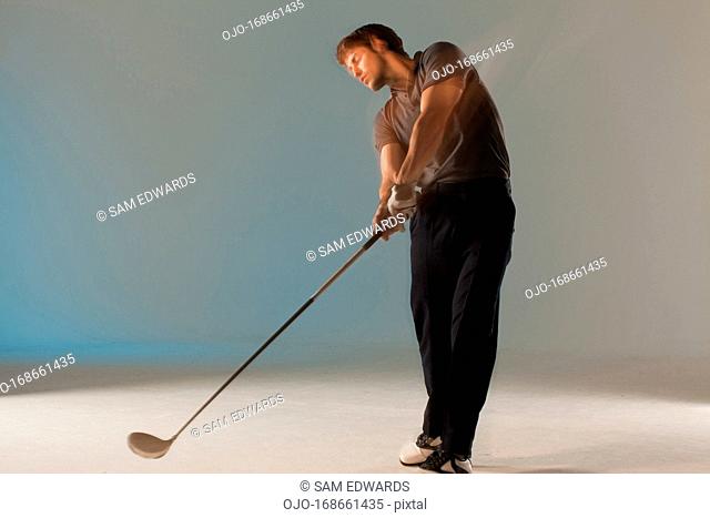 Blurred view of golf player swinging club