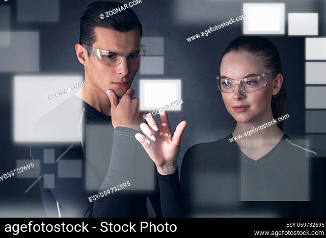 Virtual display concept, man and woman select empty rectangular space