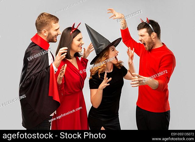 friends in halloween costumes scaring each other