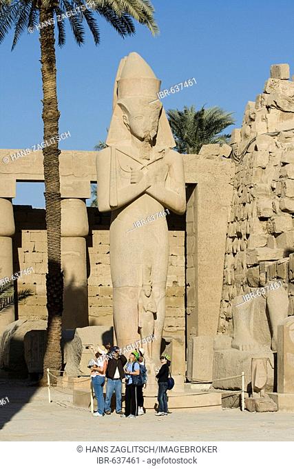 Statue of Rameses II with his daughter, Princess Bint-Anta between his legs, Great Court, Temples of Karnak, Luxor, Nile Valley, Egypt, Africa