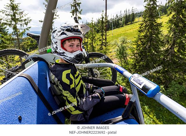 Boy with mountain bike on ski lift